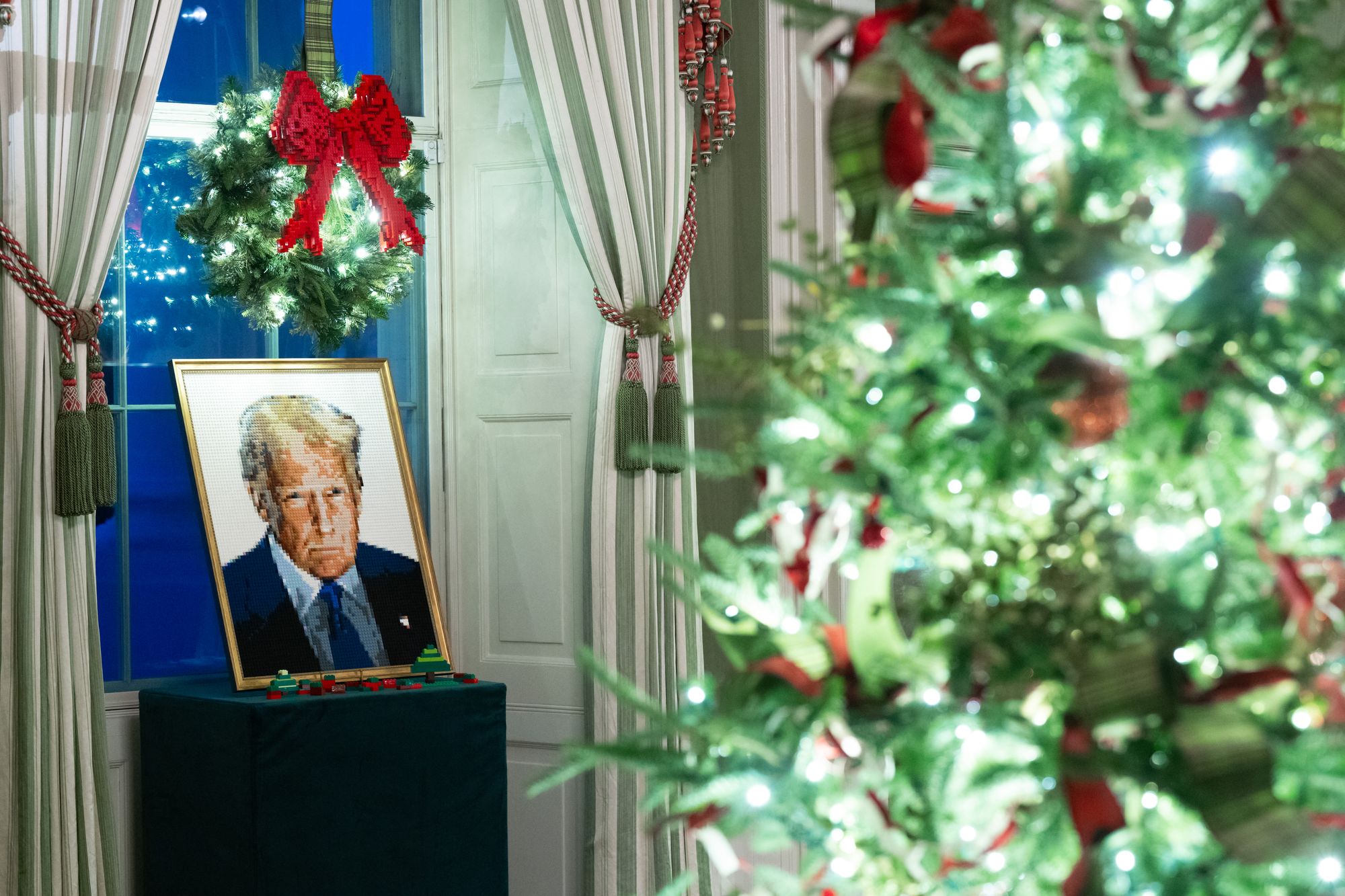 A portrait of US President Donald Trump made out of Legos is seen as part of Christmas decorations in the Green Room of the White House in Washington, DC