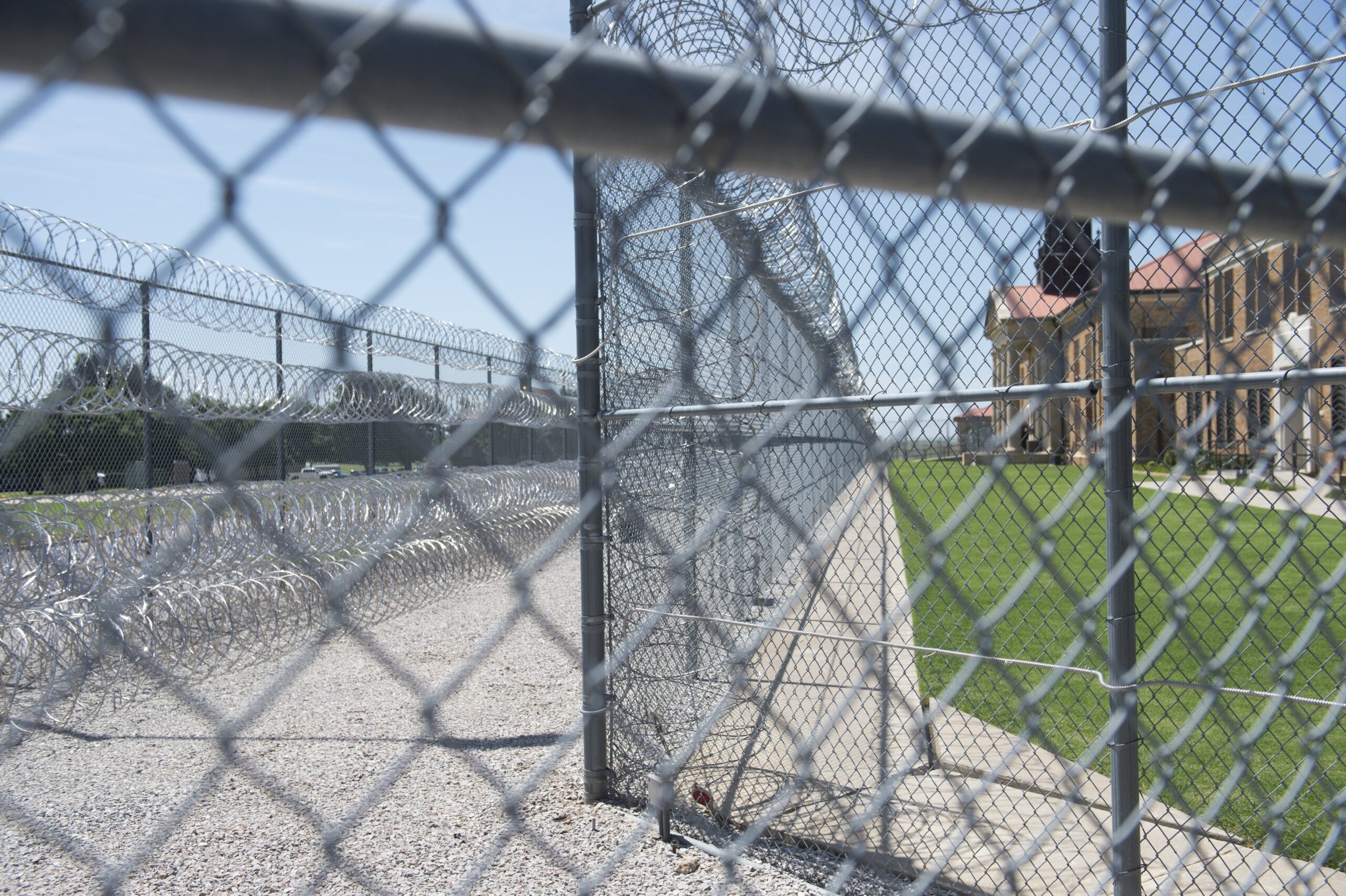 Fences and barbed wire at the entrance of the El Reno Federal Correctional Institution in El Reno, Oklahoma, July 16, 2015