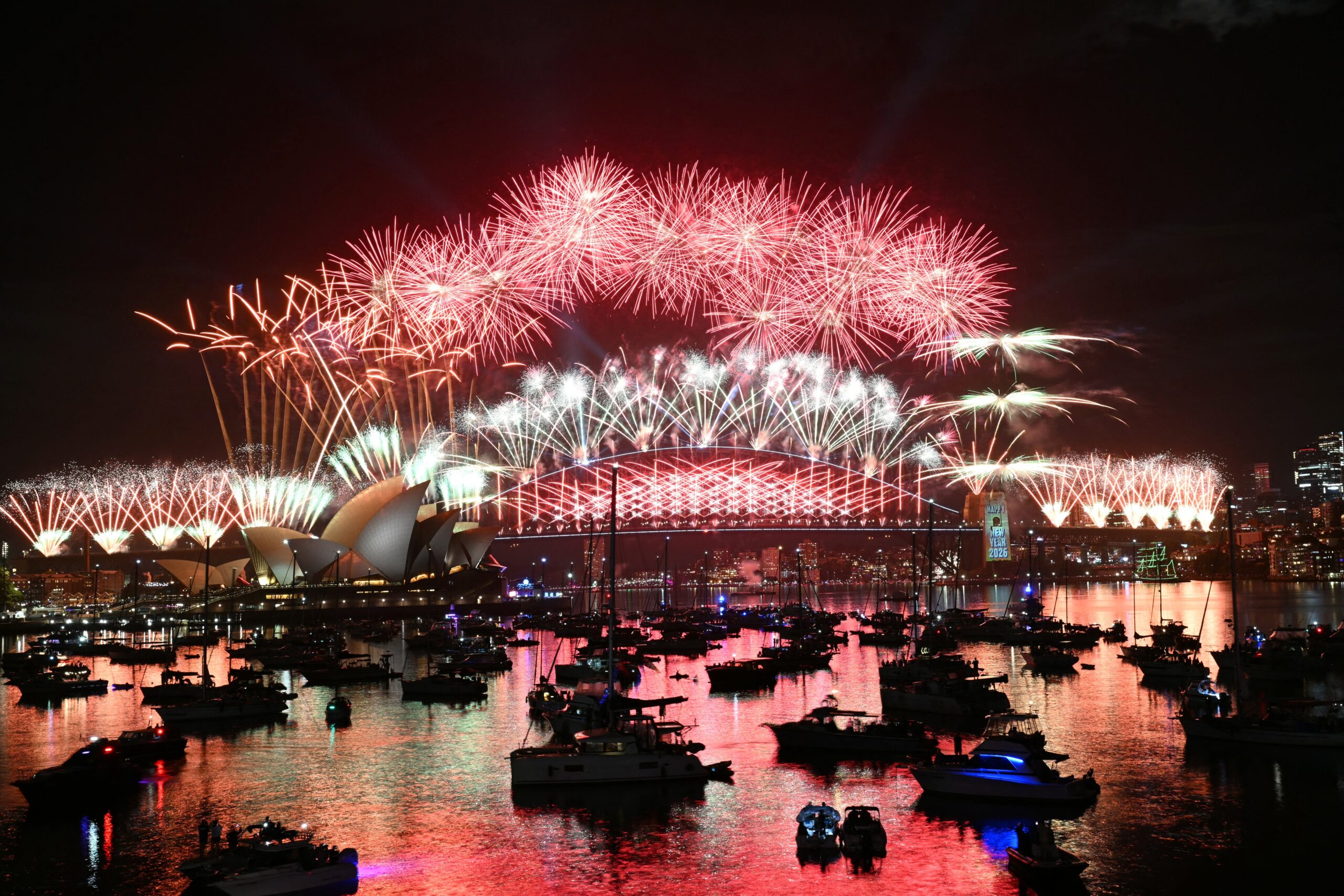 Fireworks light up the midnight sky over Sydney Harbour Bridge and Sydney Opera House during New Year's Day celebrations