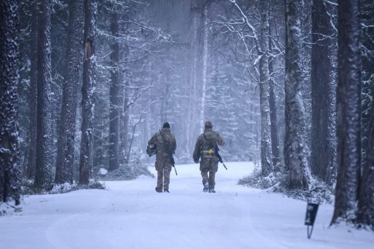 HEINUJARVI, FINLAND - NOVEMBER 19: Soldiers walk through the camp, as members of the Finnish arctic expert Jaeger Brigade train British, Swiss and french troops in cold-weather logistics on November 19, 2024 near Heinujarvi, Finland. The exercises include service members from 28 Allied and partner nations, and are taking place between November 4-24, across locations in Finland, Estonia, Germany, Poland, and Romania. (Photo by Leon Neal/Getty Images)