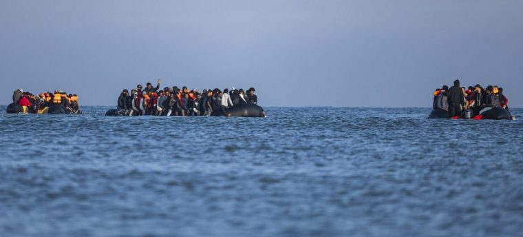(FILES) Smugglers' boats sail with migrants onboard as they attempt to cross the English Channel off the beach of Gravelines, northern France on September 27, 2025. Nine men will appear in court in Paris from November 4, 2025 for the deadly sinking of a small boat in the English Channel during the night of August 11 to 12, 2023. (Photo by Sameer Al-DOUMY / AFP) (Photo by SAMEER AL-DOUMY/AFP via Getty Images)