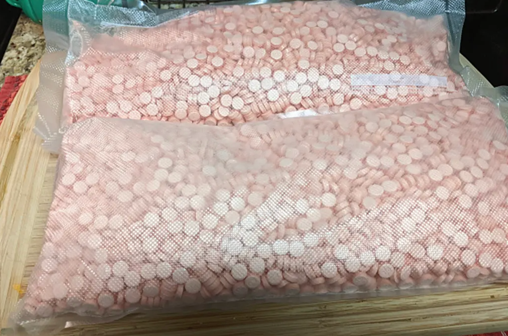 Thousands of pills were found during a raid on the woman’s home