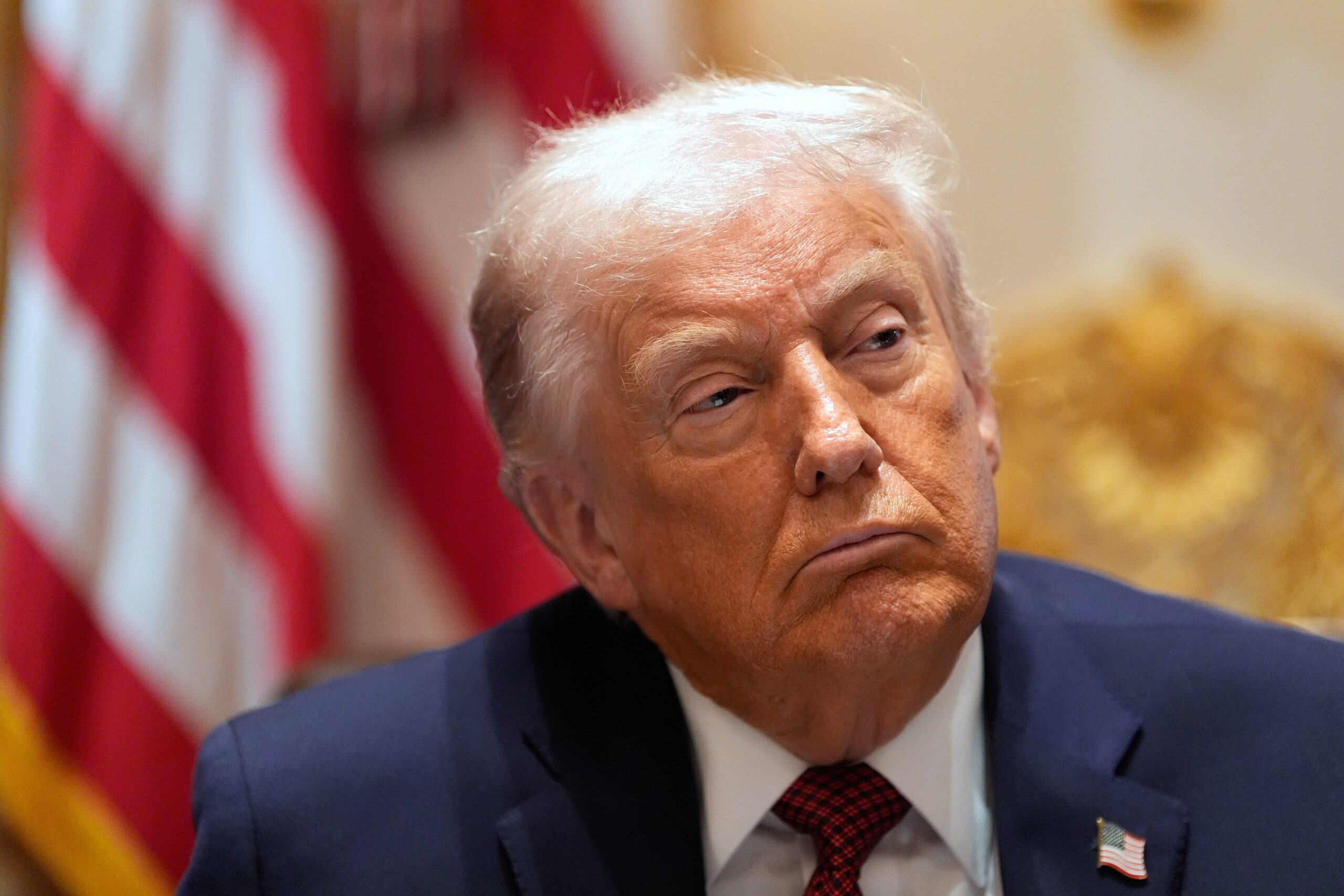 President Donald Trump listens during a roundtable in the Cabinet Room of the White House