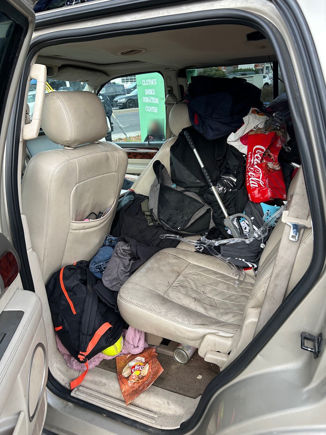 Vancouver Police arrested three adults after five children and three dogs were found living inside a cramped car teeming with garbage and drugs