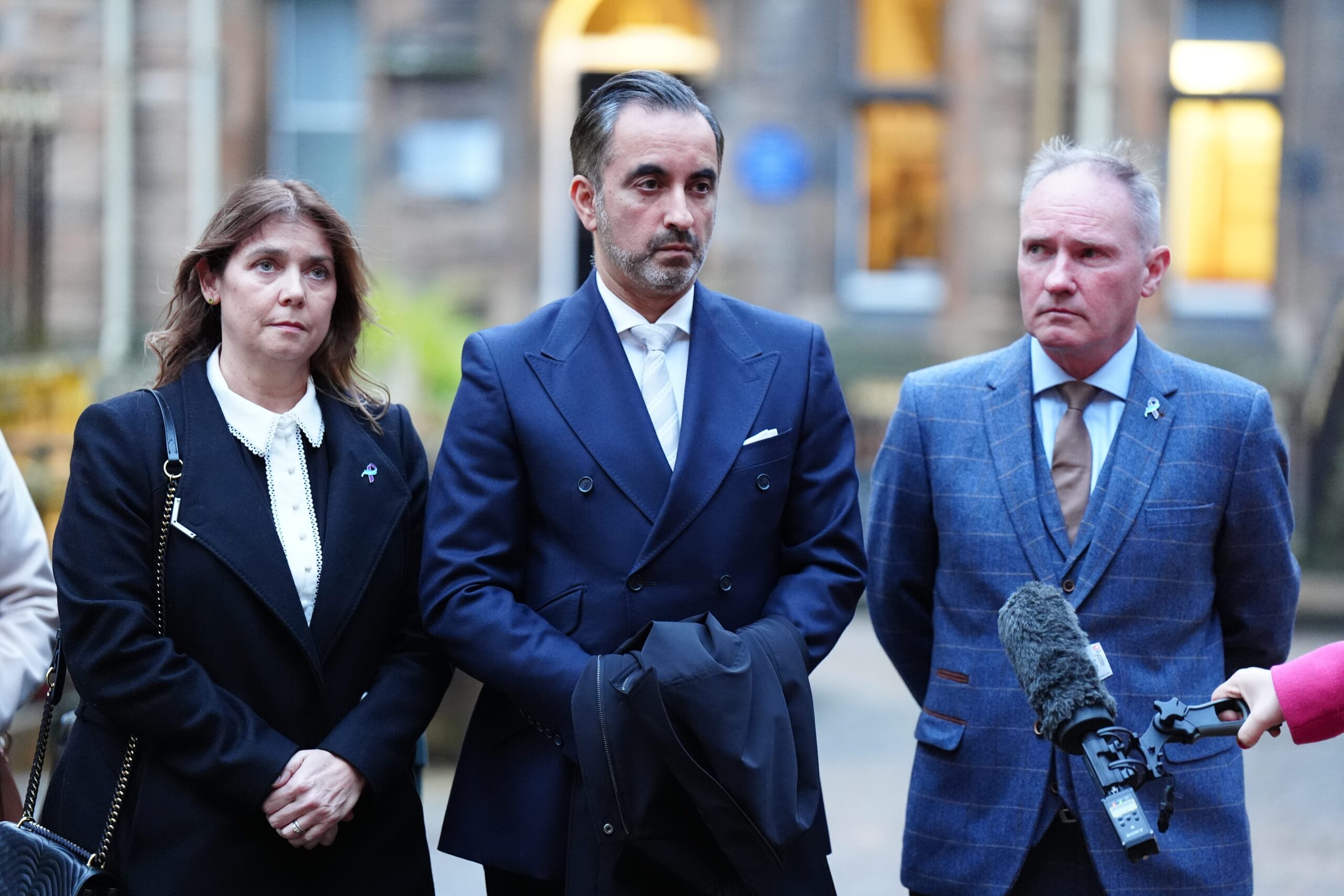 Solicitor Aamer Anwar (centre) speaking to the media, outside Bute Hall in Glasgow, with Ethan Scott Brown’s mother Tracy Scott (left) and step-father Colin Scott (right) ahead of the graduation ceremony at the University of Glasgow (Jane Barlow/PA)