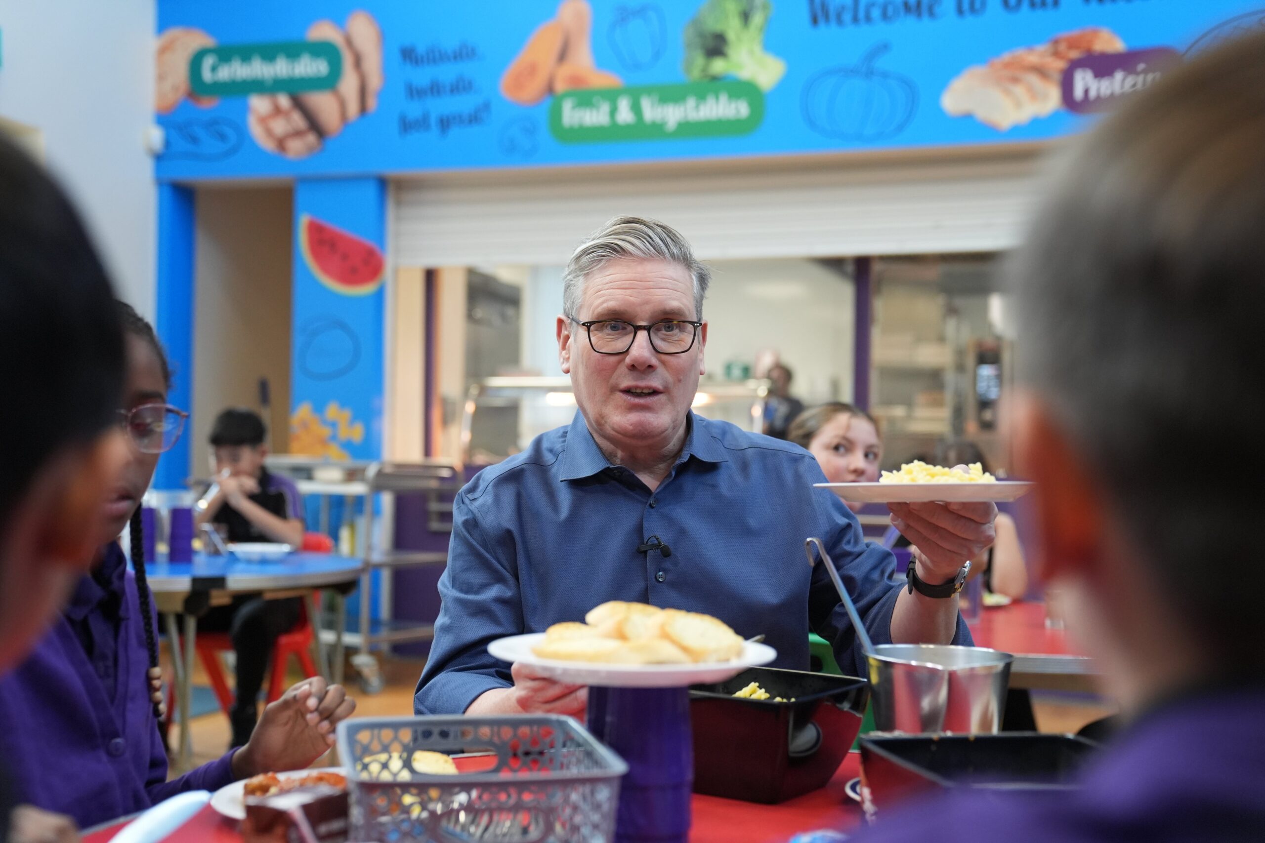 The Government is rolling out free school meals to more pupils (PA)
