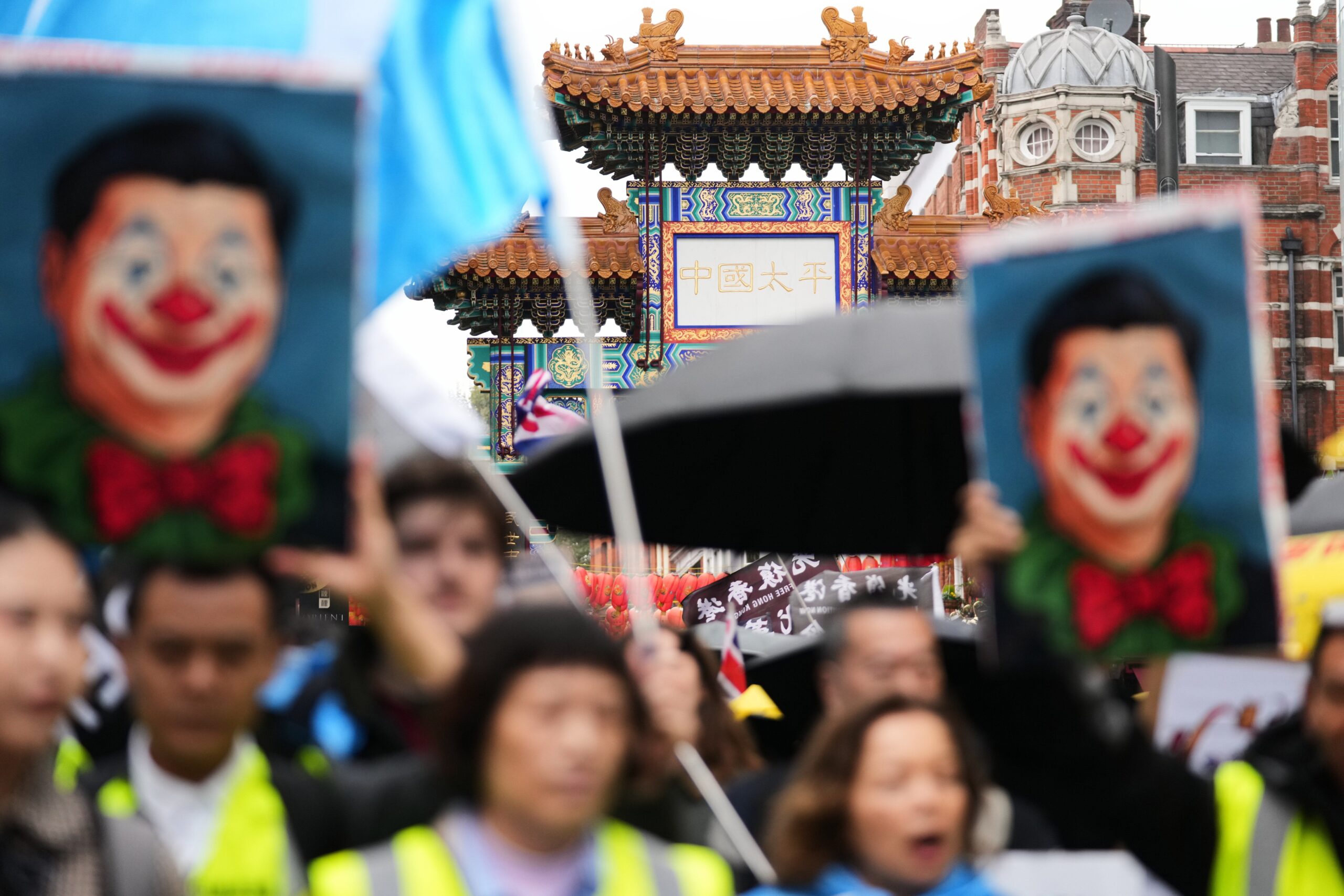 Protesters hold umbrellas, placards, and flags as they demonstrate against the proposed building of a new Chinese embassy, and to mark the 11th year of the Umbrella Revolution in Hong Kong, in London