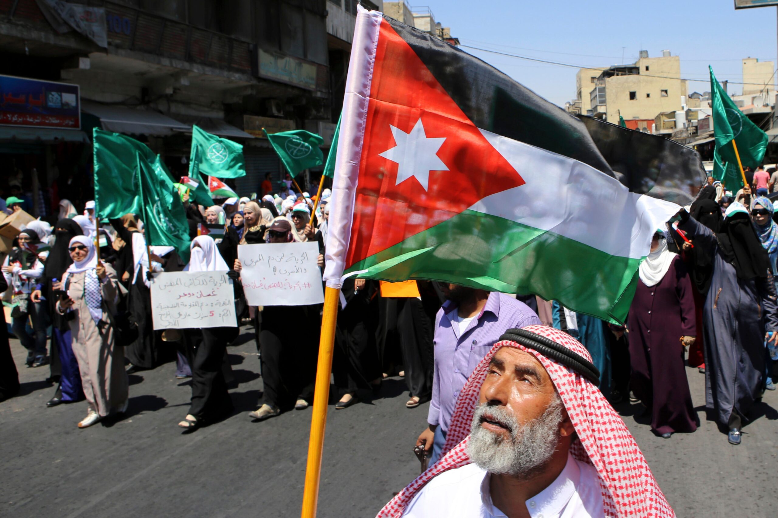 Jordanian protester carrying national flag during 2015 rally by the Muslim Brotherhood