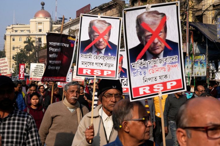 Activists of different leftist parties join a rally with defaced portraits of President Donald Trump during a protest against a U.S. military operation in Venezuela, as they march towards the U.S. Consulate, in Kolkata, India, Monday, Jan. 12, 2026. (AP Photo/Bikas Das)