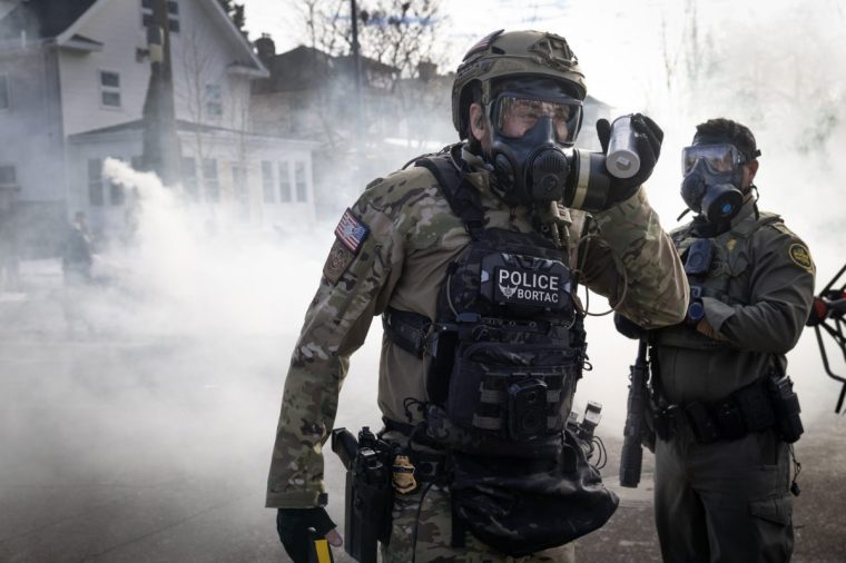 MINNEAPOLIS, MINNESOTA - JANUARY 12: Border Patrol agents deploy tear gas as they clash with residents in a residential neighborhood after a minor traffic accident on January 12, 2026 in Minneapolis, Minnesota. The Trump administration has sent an estimated 2,000 federal agents into the area as they make a push to arrest undocumented immigrants. (Photo by Scott Olson/Getty Images)