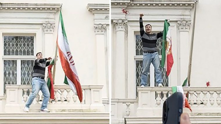An Iranian protester scaled the wall of the Iranian embassy in London to remove the regime flag and hold aloft the pre-revolutionary version (Photos: AFP via Getty Images)