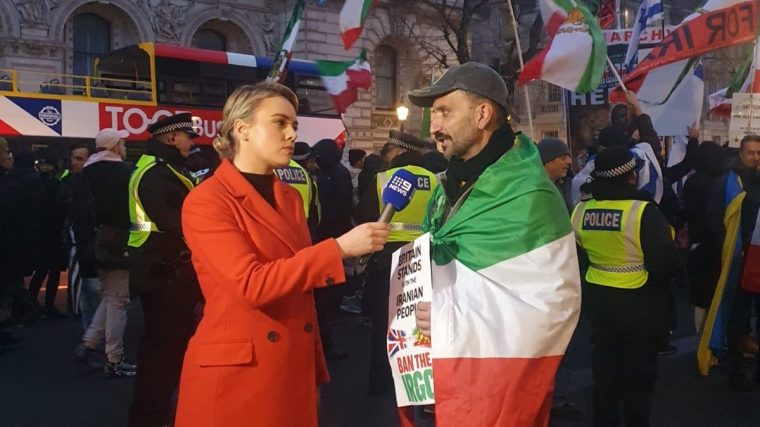 Gio Esfandeyari, seen here speaking to the media at protests in London, has begun revealing his face and name in public for the first time (Photo: Gio Esfandeyari)