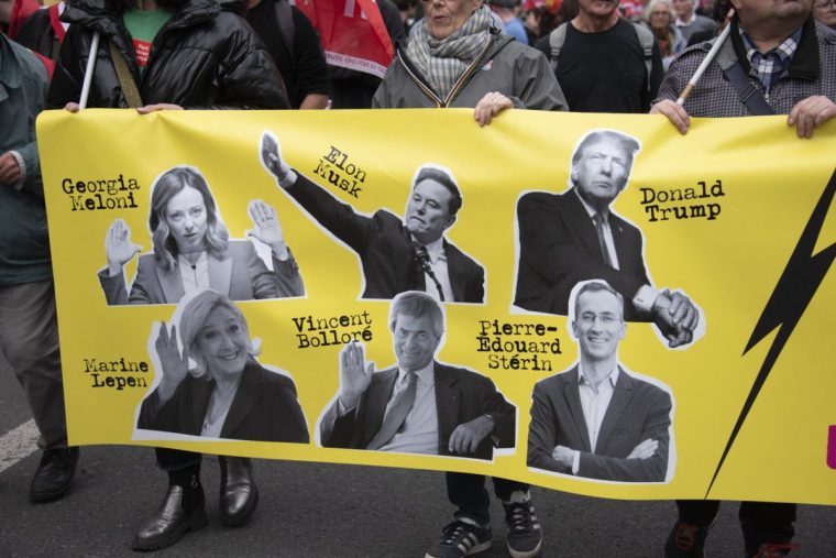A poster with the images of Elon Musk, Georgia Meloni, Donald Trump, Marine Le Pen, Vincent Bollore, Pierre Edouard Sterin during a demonstration in Paris on March 22, 2025, as part of the international day against racism and fascism. (Photo by Magali Cohen / Hans Lucas / Hans Lucas via AFP) (Photo by MAGALI COHEN/Hans Lucas/AFP via Getty Images)