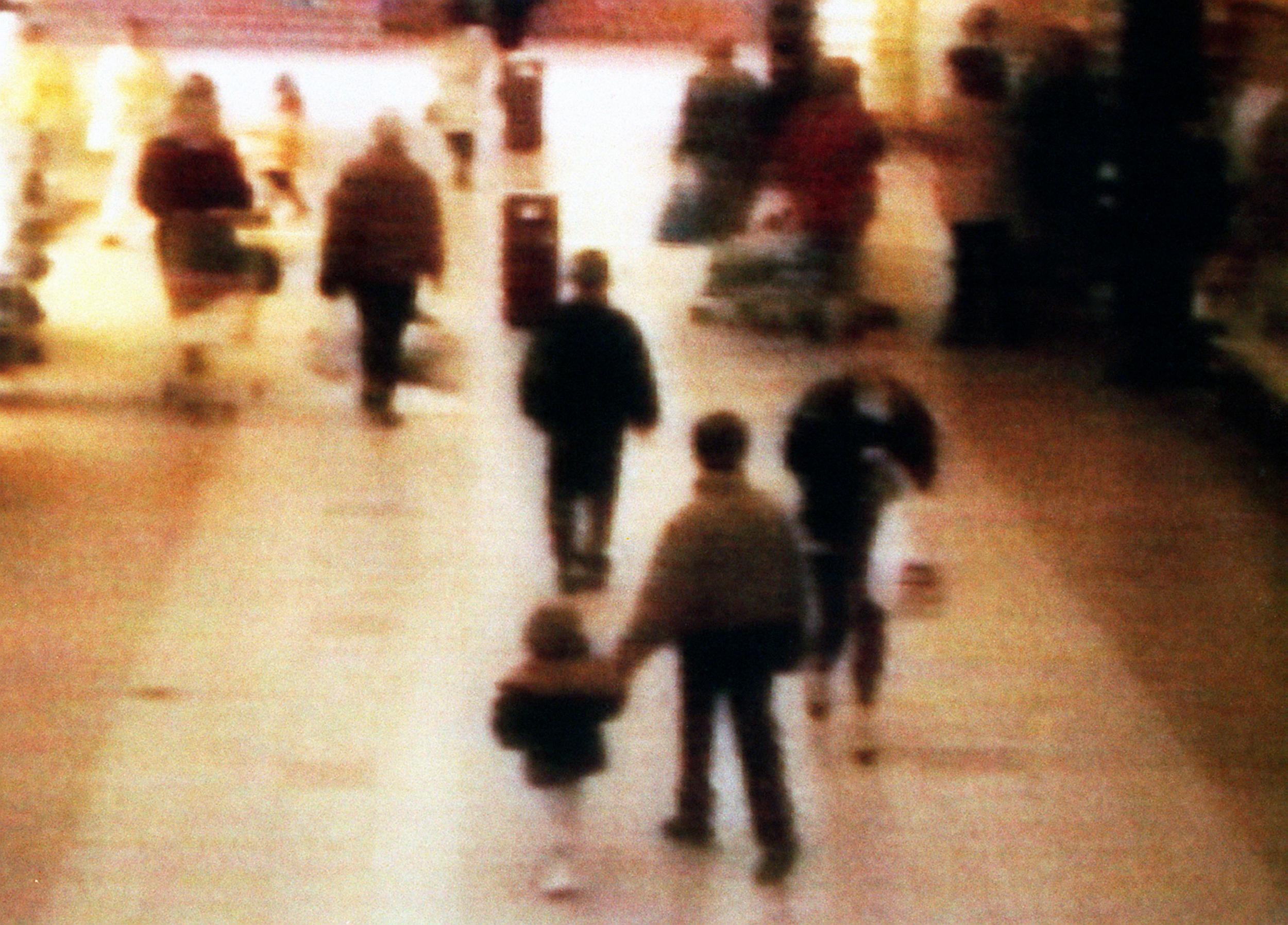 A video still of James Bulger being led away in the New Strand shopping centre