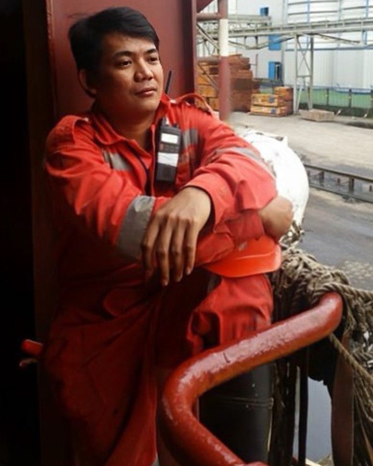 Handout photo of Mark Angelo Pernia, in a boiler suit on a ship